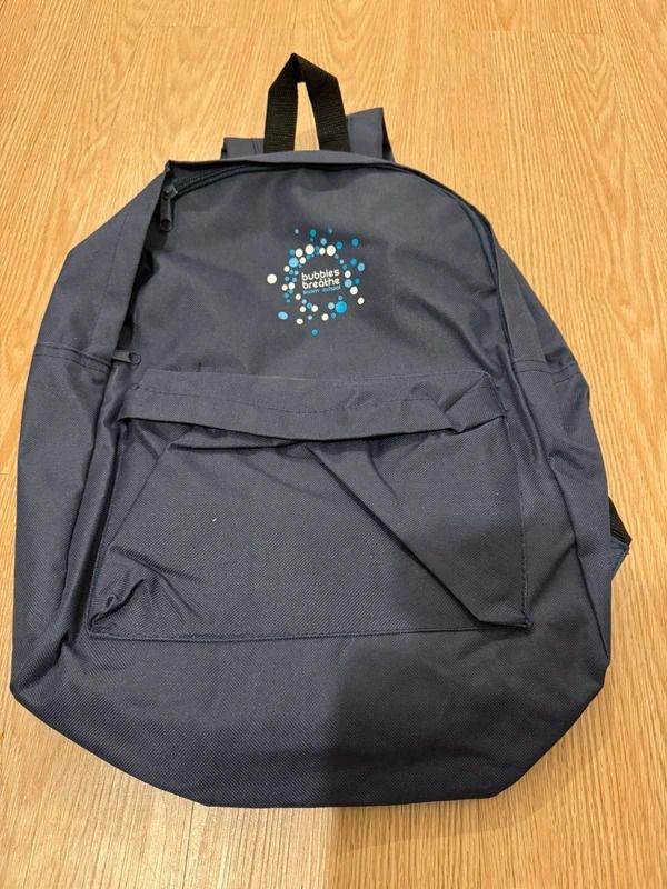 navy backpack – front pocket design with “bubbles & breathe swim school” logo
