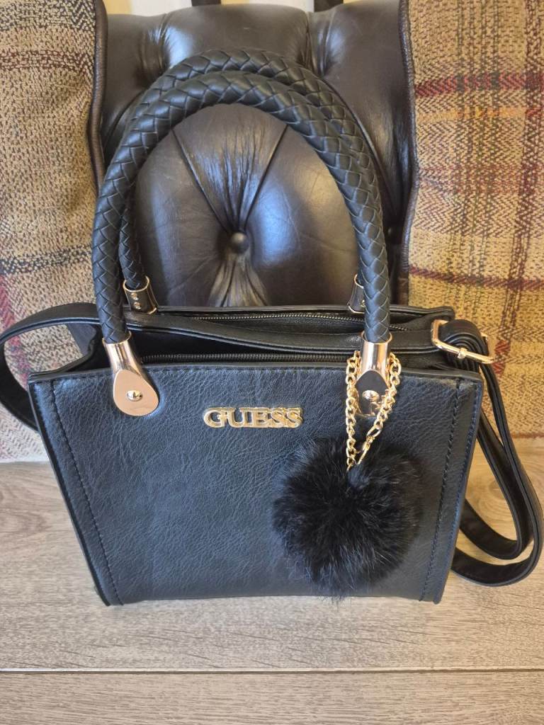 Black Guess Handbag with Pom-Pom Charm – Good Condition