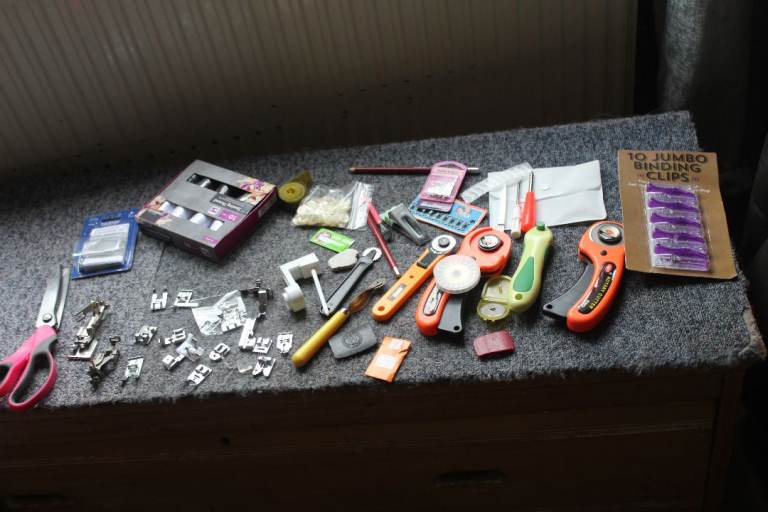 a large assortment  of sewing   materials   feet cutters 