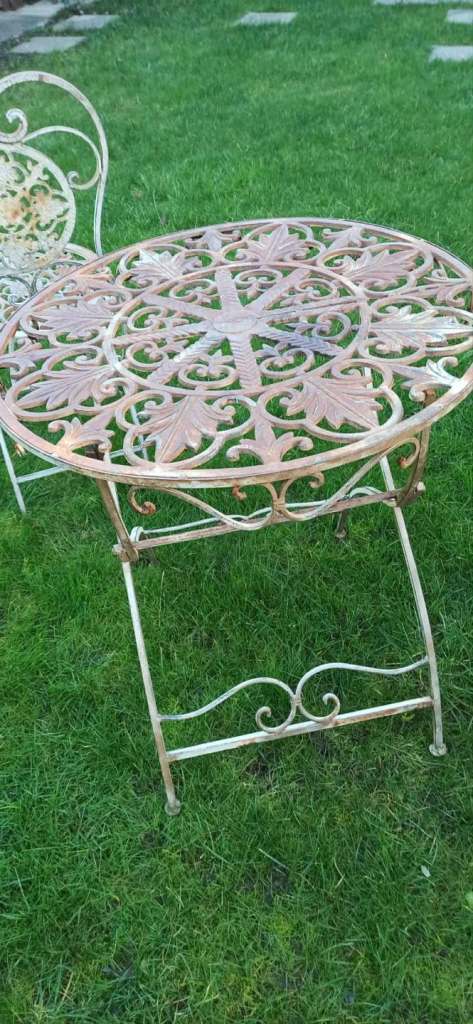 Wrought iron garden furniture set, vintage bistro set with a table and two chairs. 