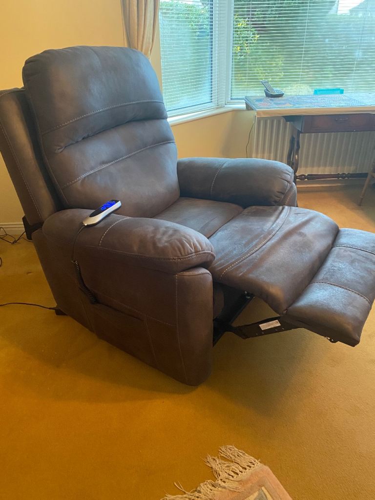 Electric rise and fall armchair in dark grey. 