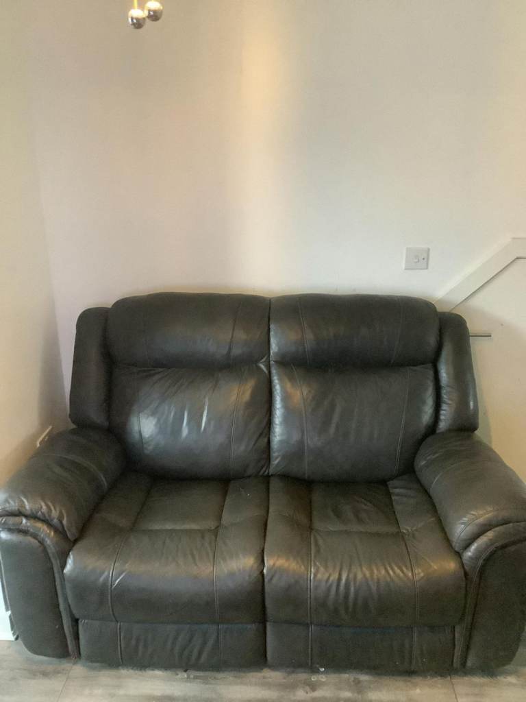 DFS Black Leather 2 seater Sofa and matching Poofy
