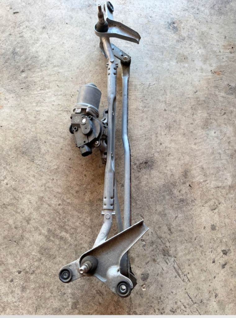 Used wiper motor and linkage assembly, removed from a working vehicle.