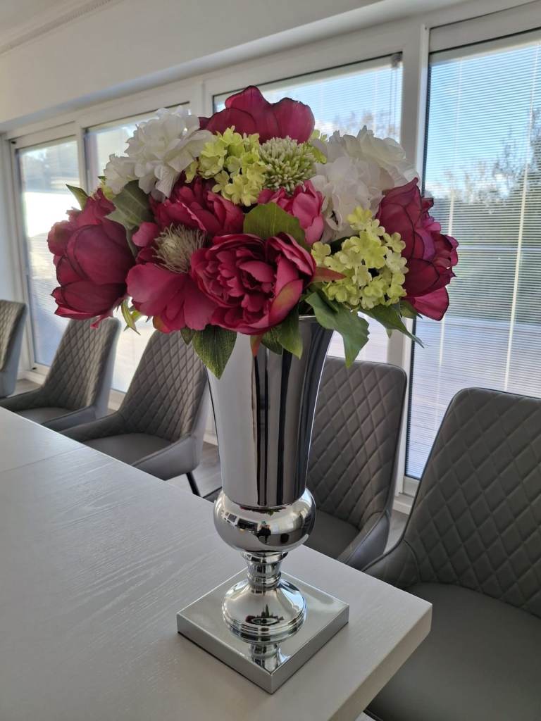 Silk flower arrangement in silver vase