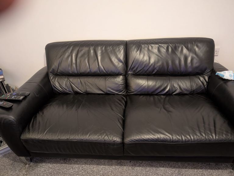 Black sofa and footstool 