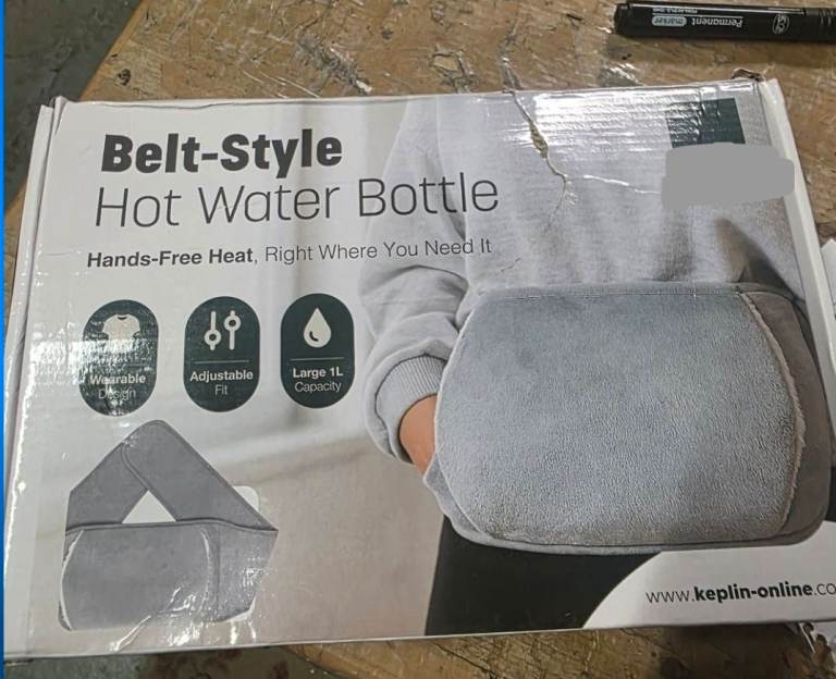 A new still boxed soft touch belt style hot water bottle .