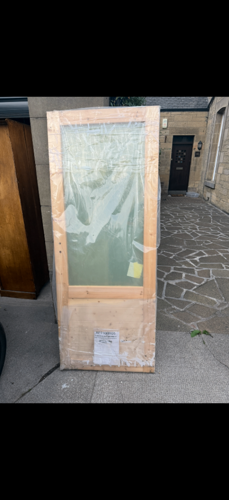 new, unused timber half-glazed external door