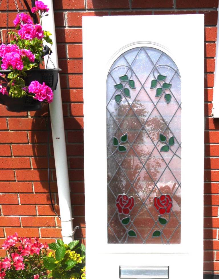 Upvc front door panel insert with roses and leaves pattern on the glass. See photos and description