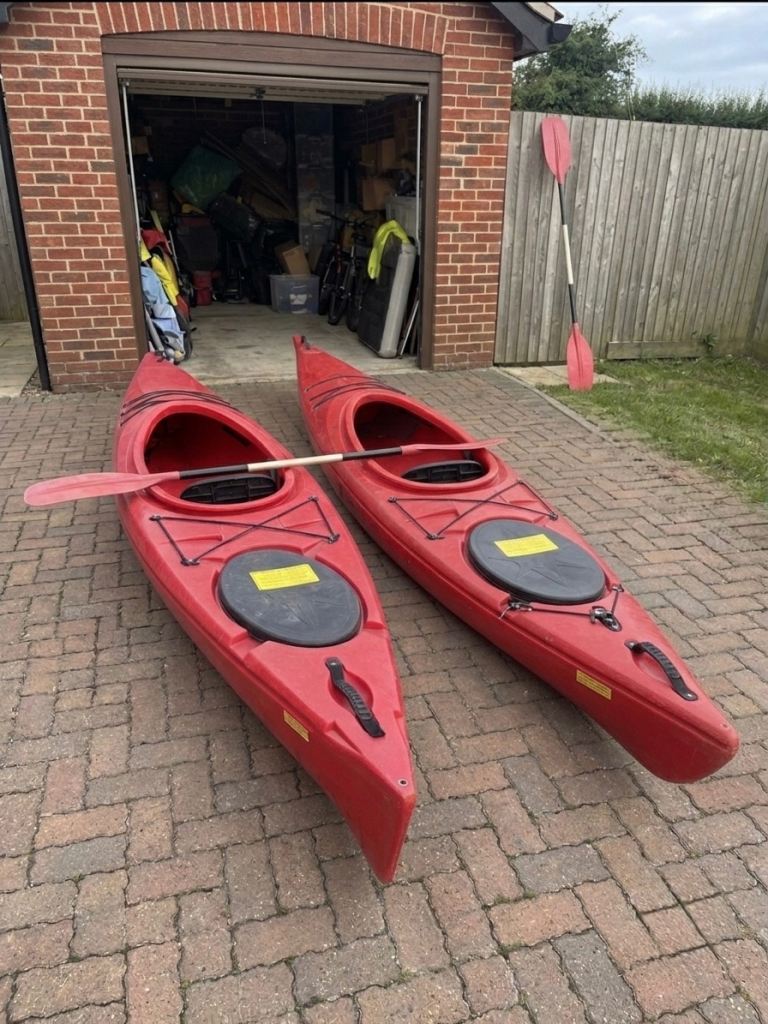 Pair of Red Kayaks with Paddles – Good Condition