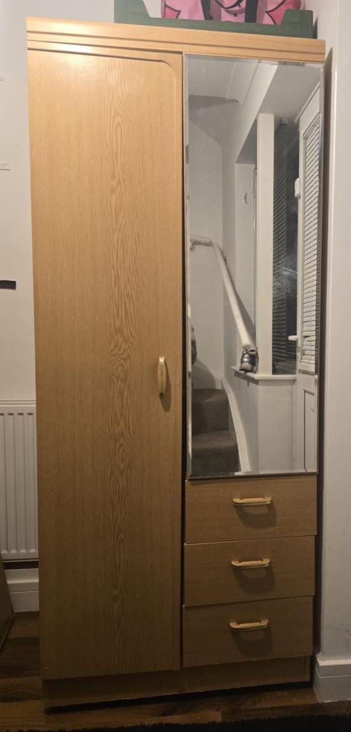 cabinet with two doors and two drawers, with a mirror on the door