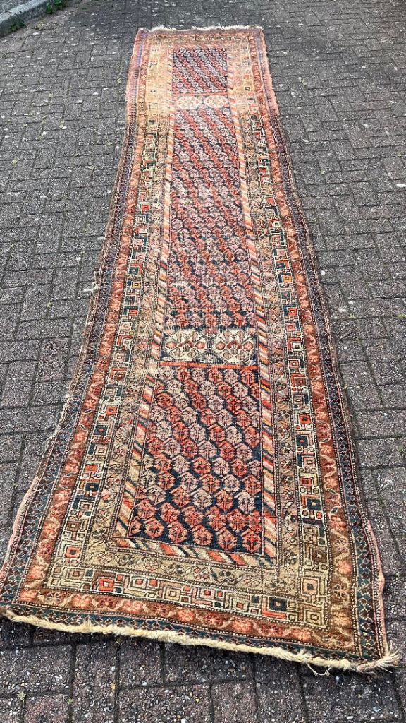 A long Persian vintage runner rug 