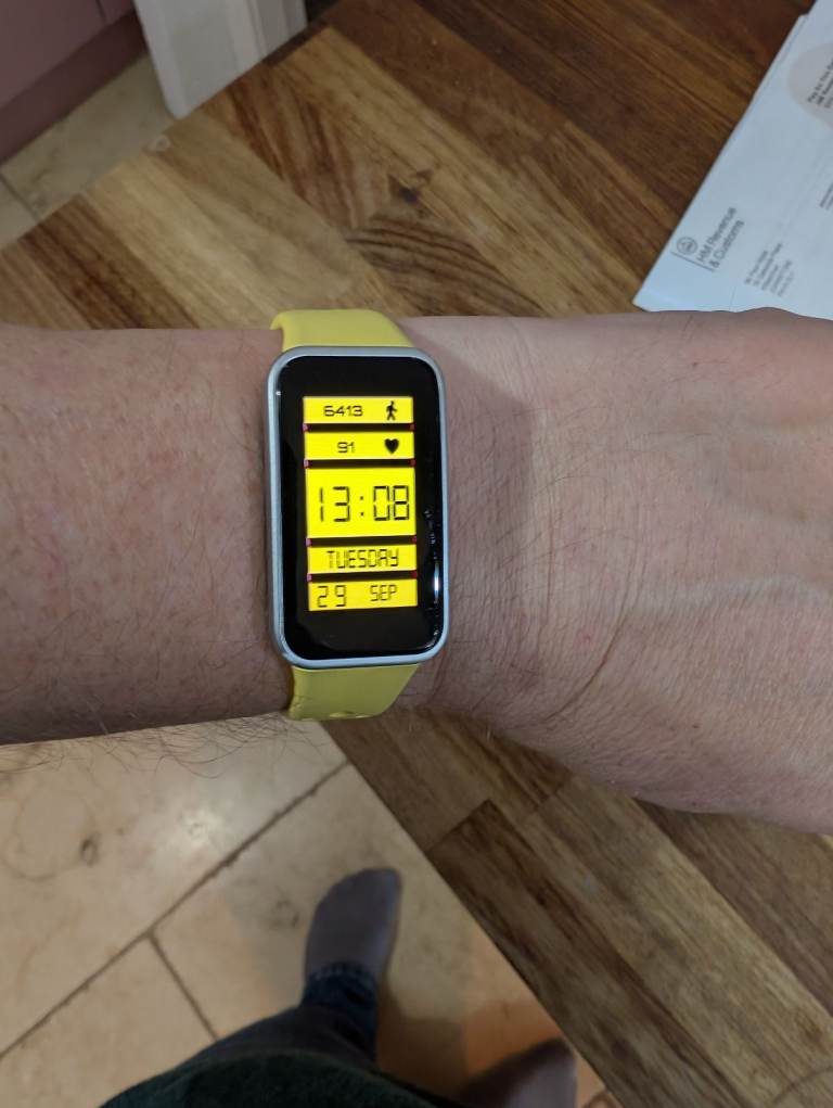Huawei Band 9 Smartwatch with Yellow Strap – Good Condition. Comes with two charging cables. 