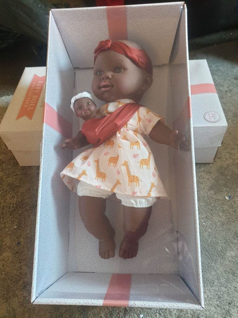 Childs doll carrying  baby