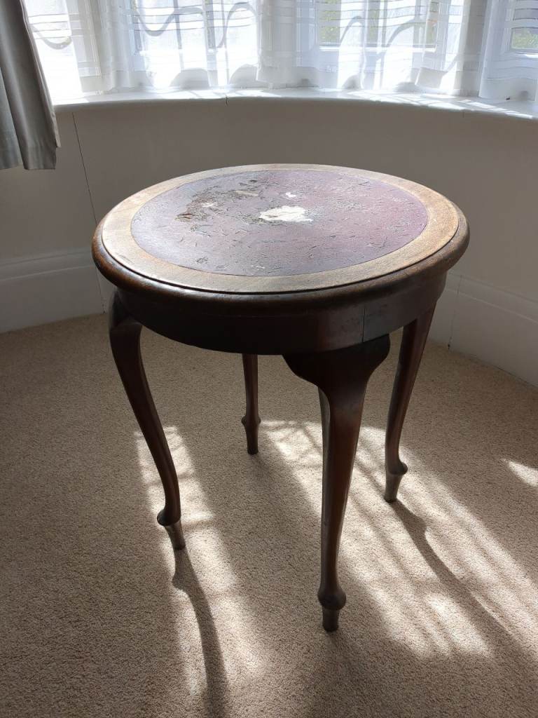 Pub table with some damage to surface.