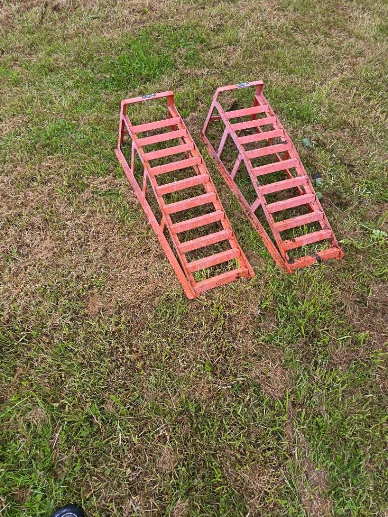 A pair of metal car ramps