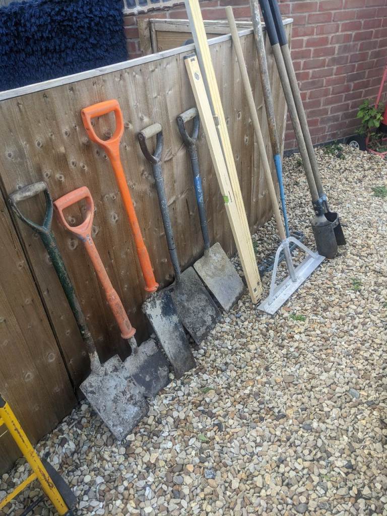 Selection of Garden Tools: Spades, Shovels, Rake, and Level