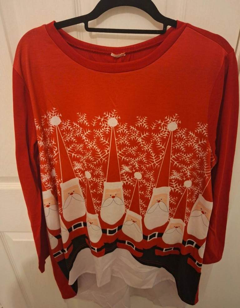 Thin red long-sleeved top with santas and snowflakes. Shirt type material lining underneath. Size 20