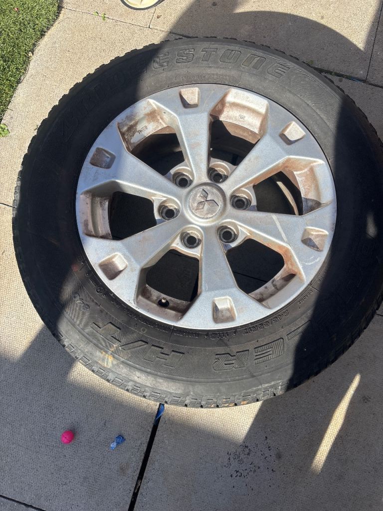 Pair of Mitsubishi rims a tires 