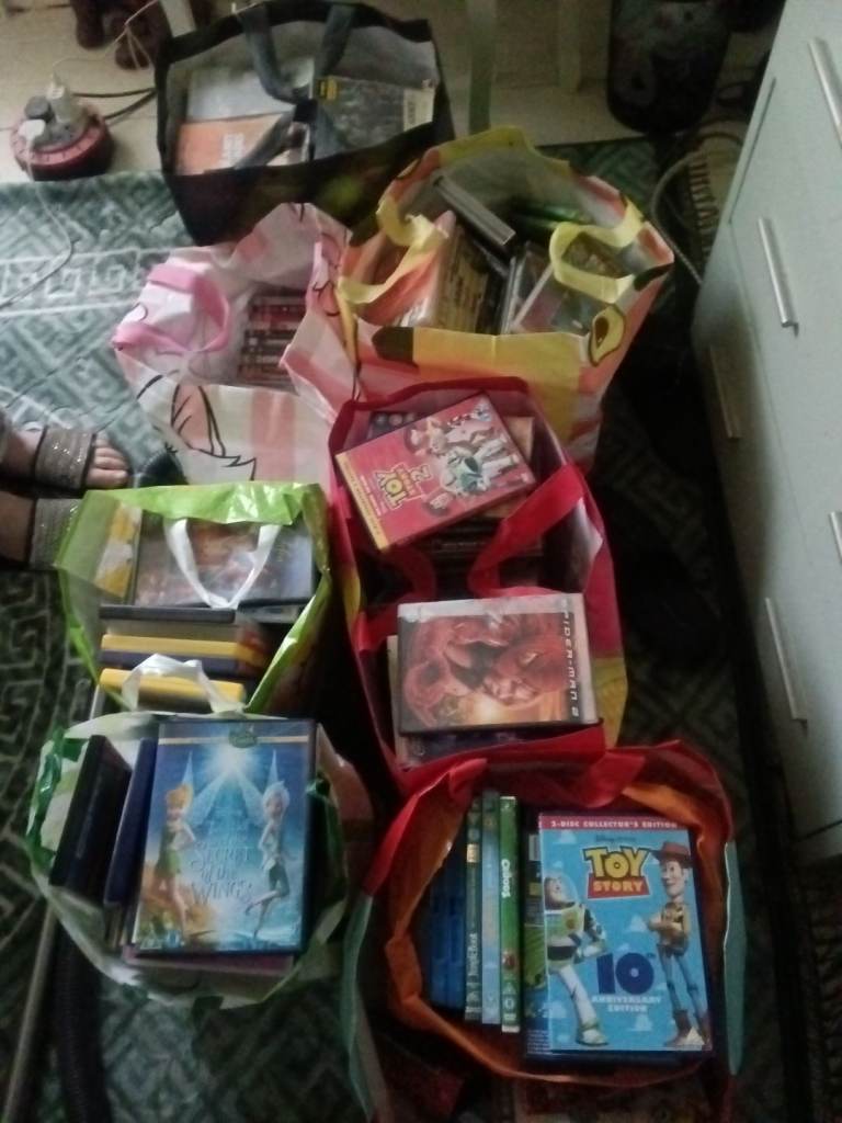 Seven full bags of assorted dvds