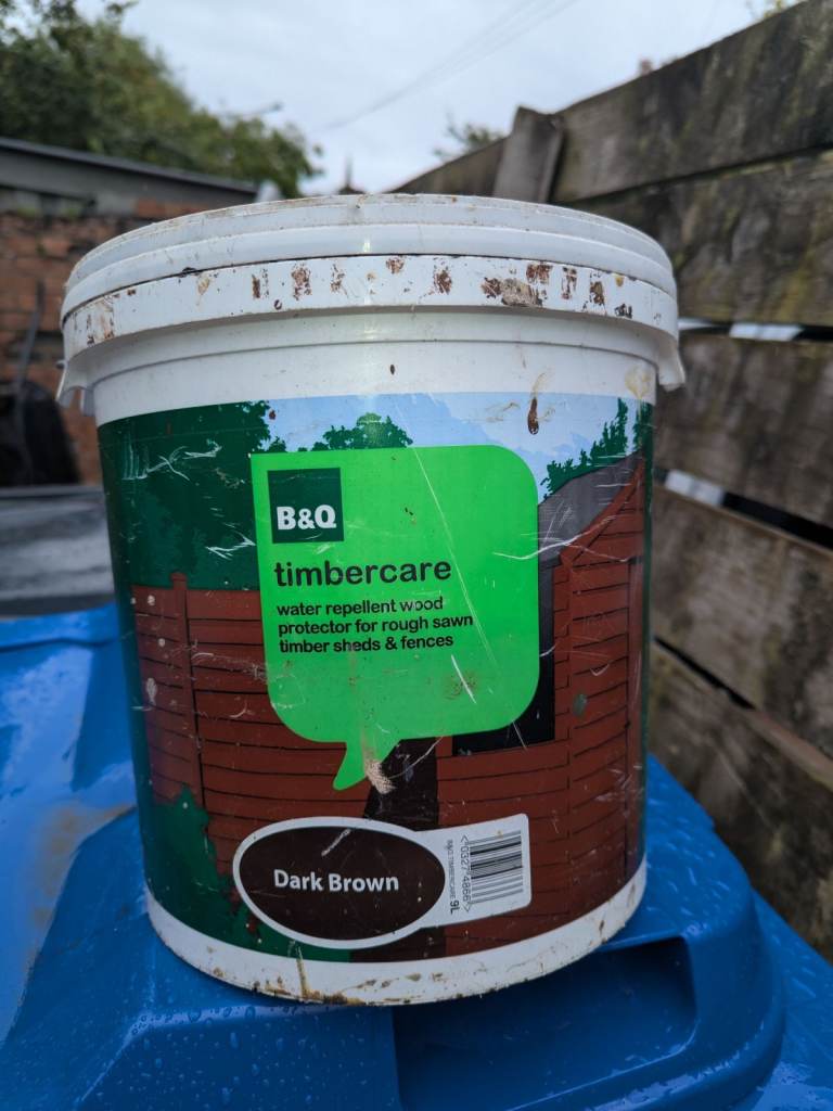 2 opened tubs of dark brown woodstain