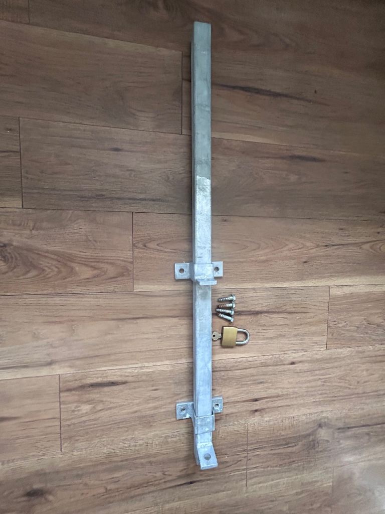 Steel security bar for wooden garage/shed doors