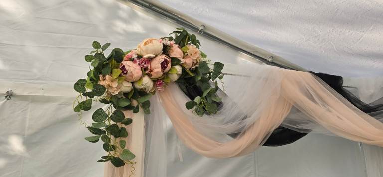 Wedding arch backdrop floral voil display.
