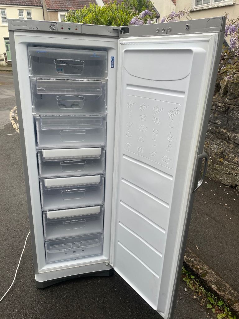 Indesit upright freezer in good working order, perfect for extra storage.