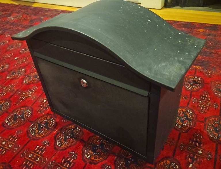 Black metal post box with keys