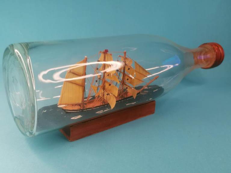 Antique Ship in a Glass Bottle 20th. century English model ship in a bottle.