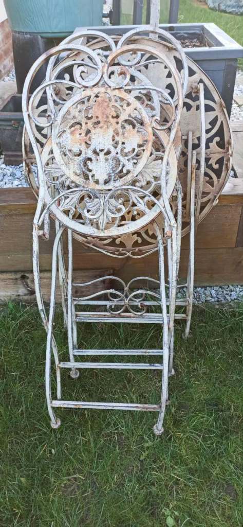 Wrought iron garden furniture set, vintage bistro set with a table and two chairs. 