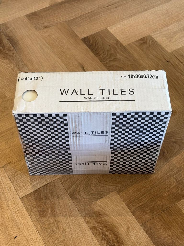 Unopened box of white subway tiles 4” x 12”