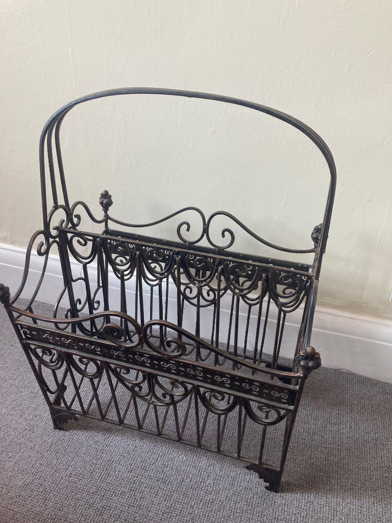 Large ornate metal magazine rack with handle