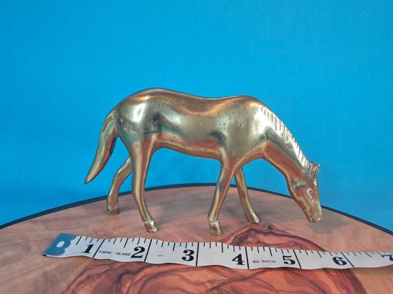 This is a mid-century vintage brass horse figurine, described as a grazing horse. As seen. 