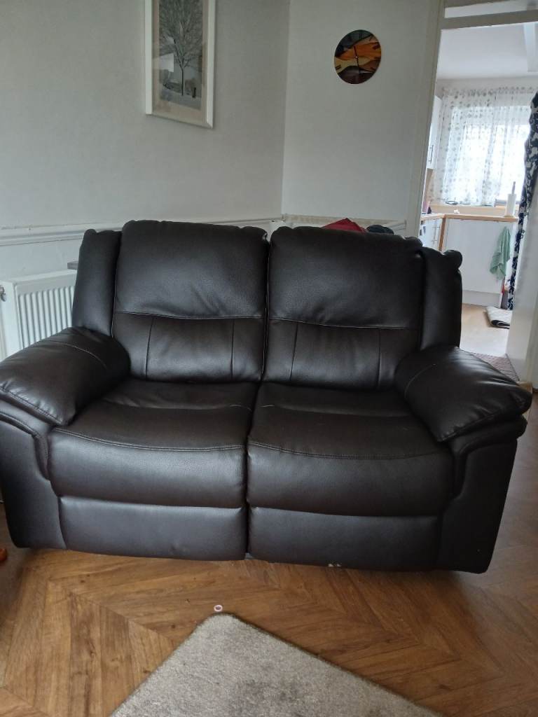 Two brown leather sofas