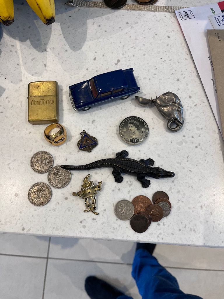 Assorted Collectibles: Lighter, Toy Car, Coins, and Figures