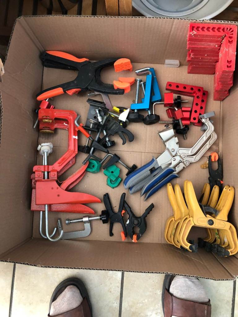 Tray full of assorted types of small clamps, Automaxx clamps,  and corner  positioning squares,