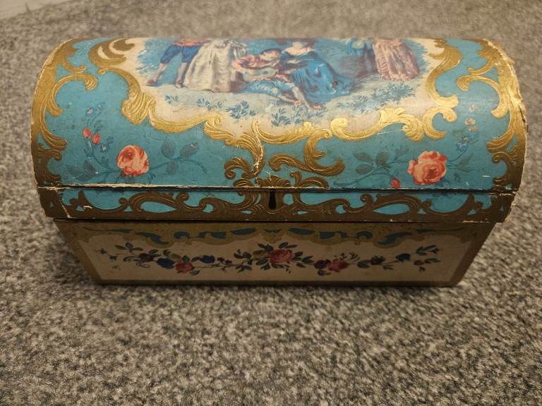 Decorative vintage cardboard box containing assortment of vintage buttons