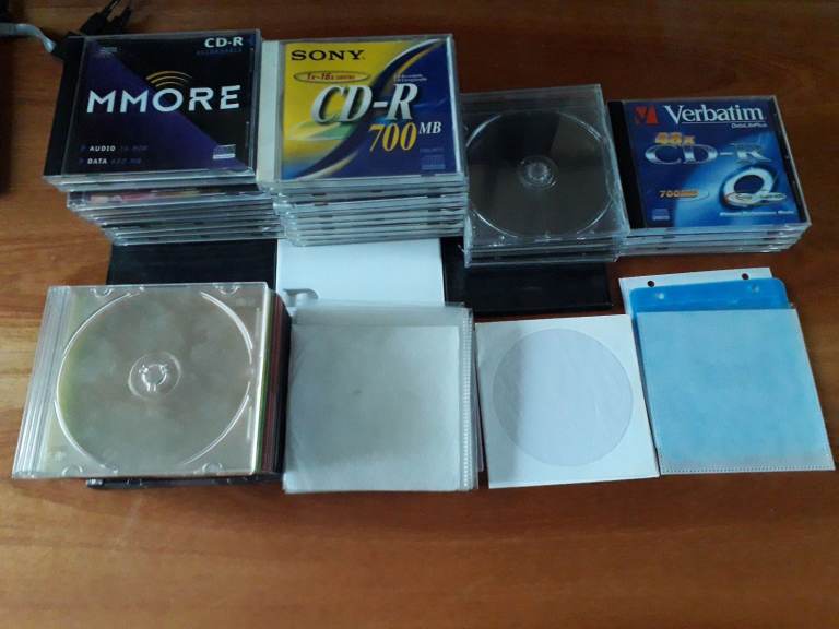 Large collection of DVD/CD boxes/containers/cases and sleeves.