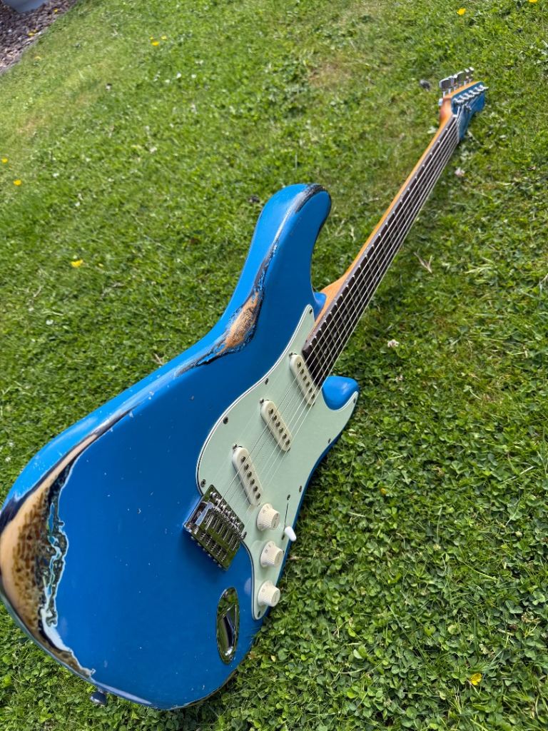 Reliced electric guitar, Stratocaster shape with Squier pickups. 