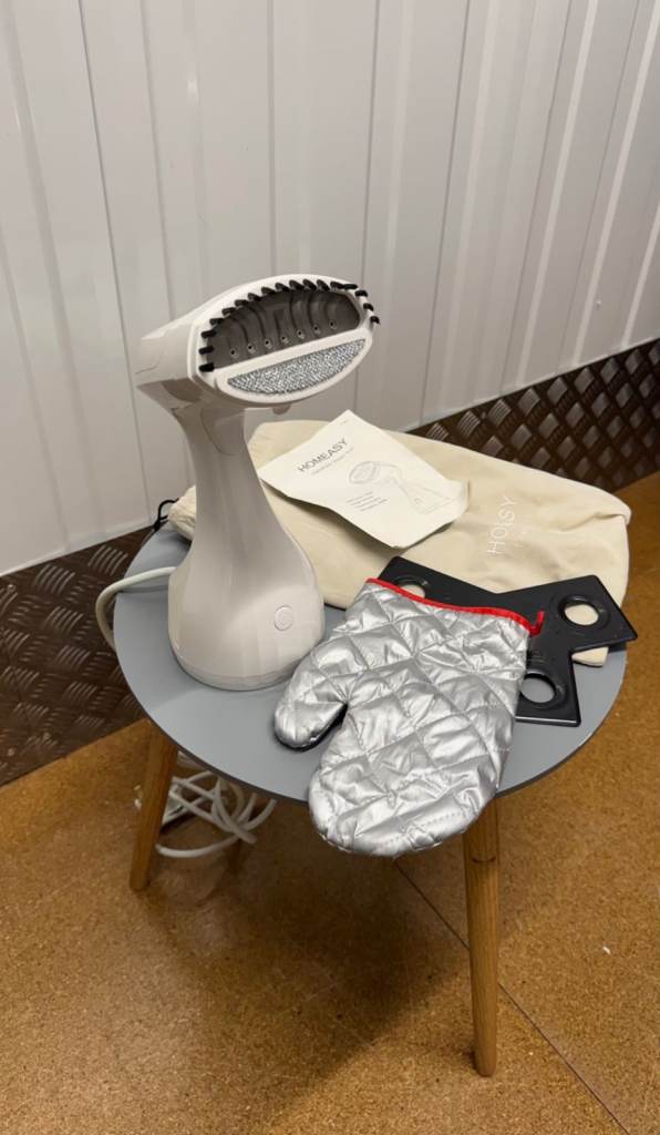 Handheld clothes steamer includes glove and bag