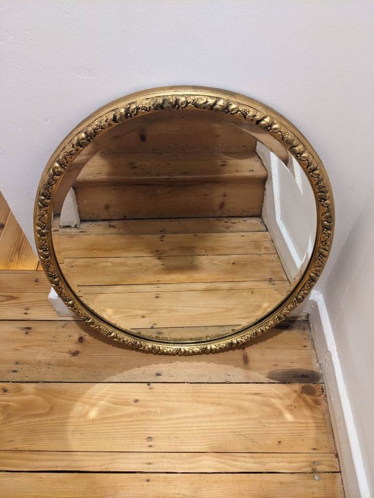 Oval gold-framed mirror 