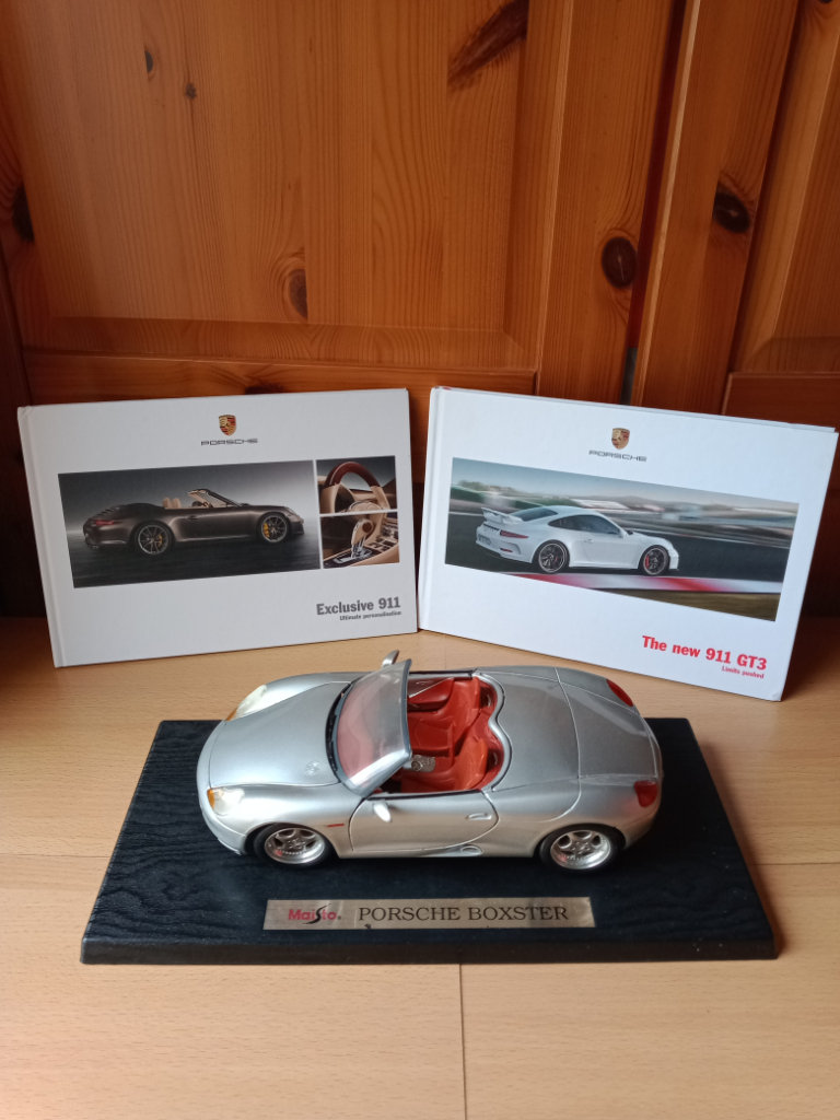 1/18 Maisto model Porsche Boxster and two Porsche 911 Hardback catalogues