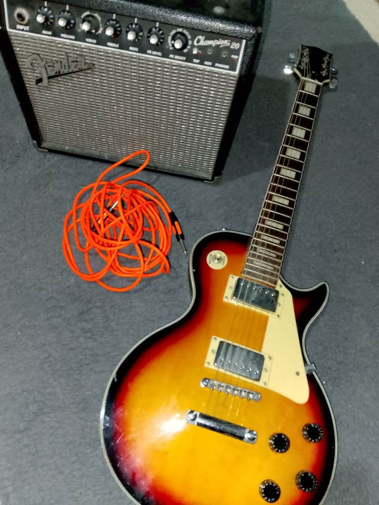Swift les paul style sunburst electric guitar with Amp and jack cable. 