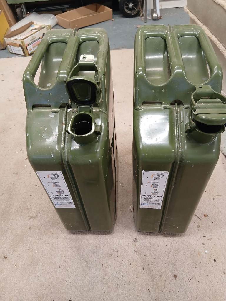 A pair of 20l metal jerry fuel cans with spout.