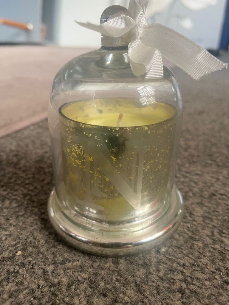 NEW SILVER CANDLE WITH GLASS DOME OVER IT WITH INITIAL N ON THE FRONT