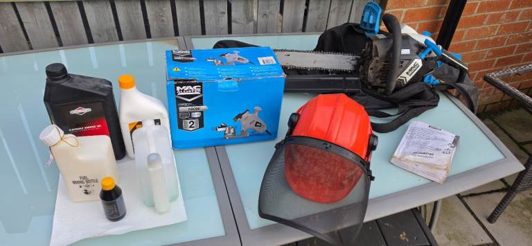 Chainsaw, chain sharpener and safety helmet with visor