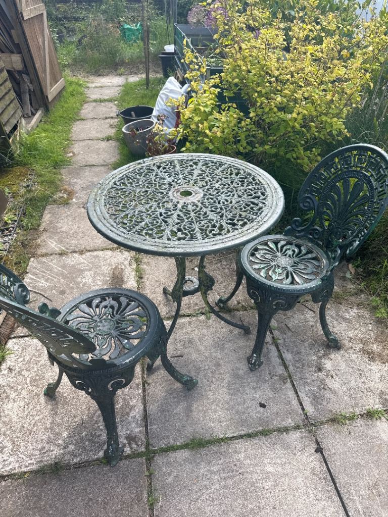 Green garden cast iron chairs and table 