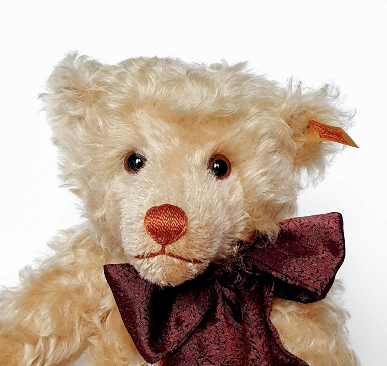 Steiff Bear with Bow and tag with gold plated button. Approx 12 inches