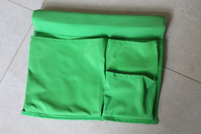 stickat Ikea bed pocket green storage books side of bed 