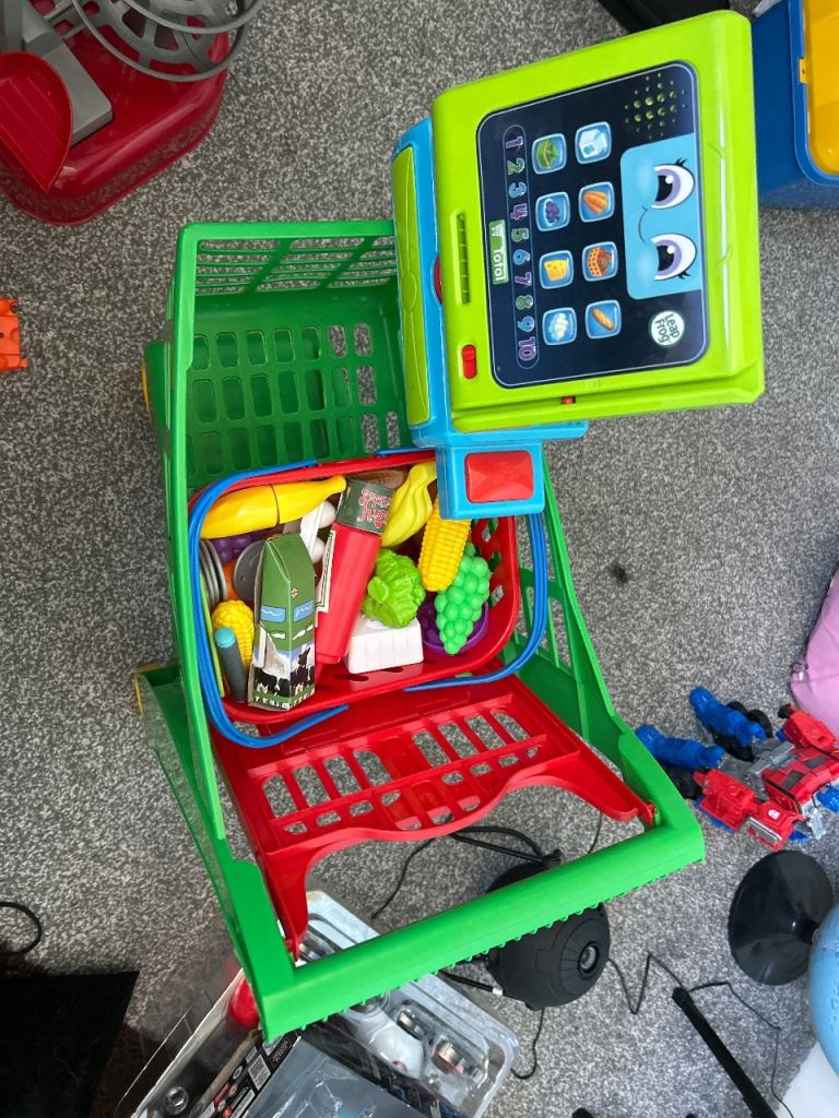 Kids shopping trolley with basket, checkout, and shop items